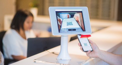 Man using QR code to pay at a hotel